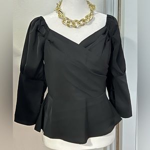 Black peplum top. Zipper on the side. Polyester material.